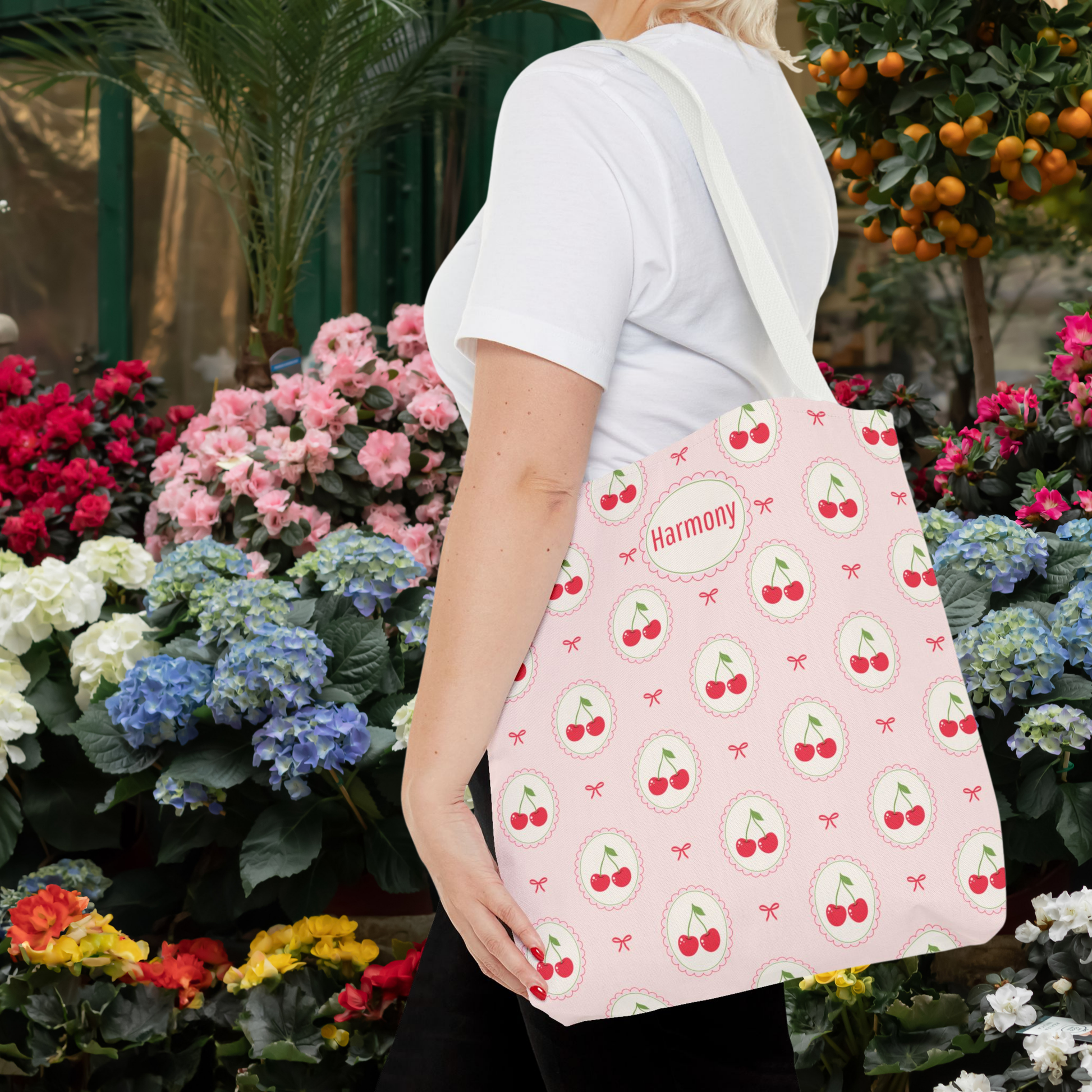 Custom pink cherry bag featuring a pastel fruit pattern with repeating cherries and sweet bow details. This personalized tote has a Kawaii and Cutecore inspired aesthetic and makes a cute accessory for tweens, teenagers, teachers, back to school, shopping trips, summer vacations, or everyday errands.
