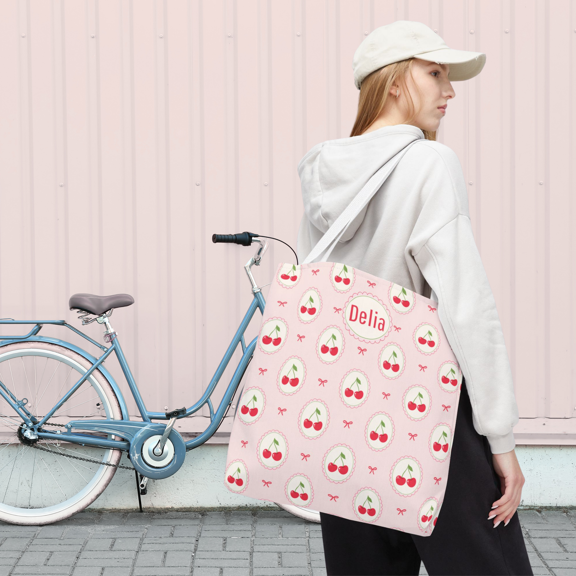 Personalized tote featuring a soft pink cherry aesthetic with repeating cherry medallions and pink bows. This cute Cutecore accessory can be customized with a name or monogram and works as a teacher tote, reusable grocery bag, beach tote, school bag, or everyday carryall.
