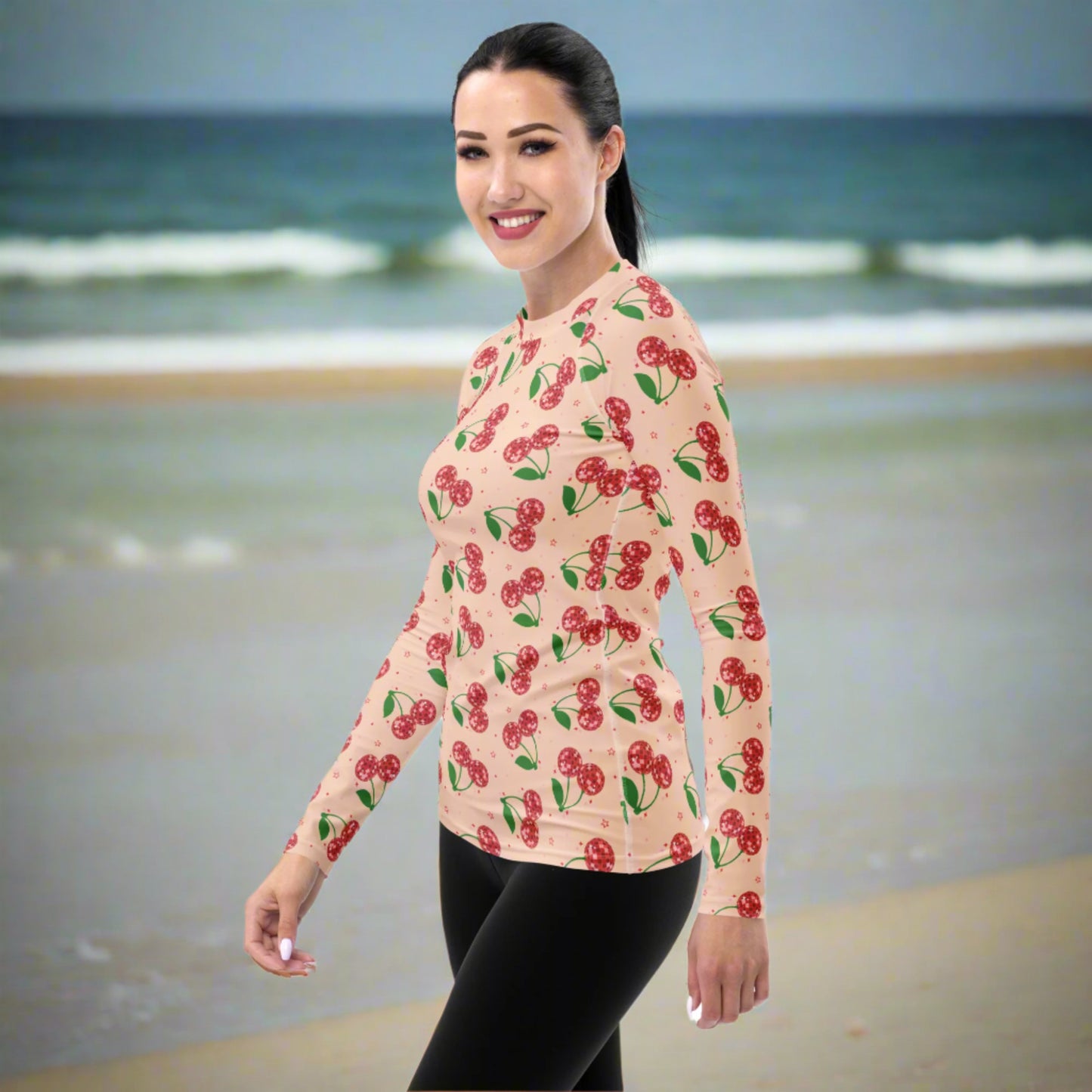 Disco cherry women’s swim top featuring a vibrant fruit inspired design, long sleeve coverage, and flexible performance fabric for swimming, surfing, paddleboarding, boating, and outdoor adventures.