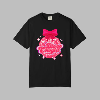 Women's Disco Cowgirl graphic t-shirt features a large disco ball, hot pink coquette bow, and star-speckled background with “Disco Cowgirl” in playful script. This Comfort Colors tee is a top pick for western-themed events, fun bachelorette outings, or cozy Nashville nights. Soft, garment-dyed cotton in sizes S–4XL makes it a cute and comfy must-have.