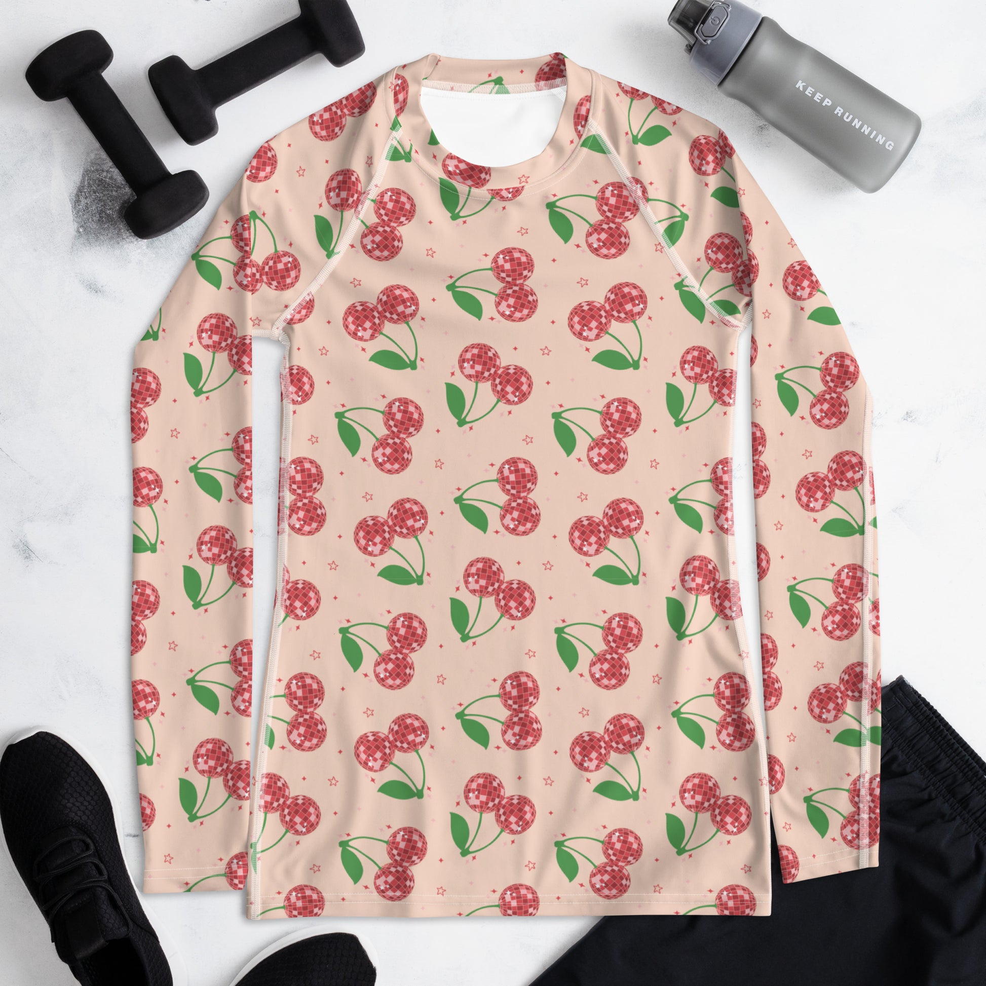 Women’s UPF 50+ swim rash guard with a bold disco cherries pattern, long sleeves, and comfortable stretch fabric, combining fun retro fashion with practical sun protection for beach and outdoor activities.