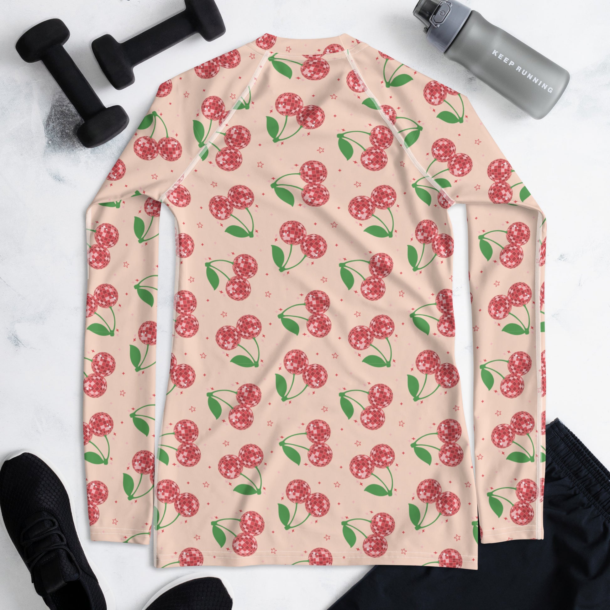 Retro cherry rash guard for women featuring bright playful cherries on a stylish swim top designed for sun protection, active days by the water, poolside lounging, and unique summer vacation outfits.