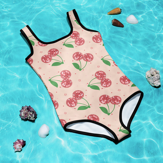 Cute and colorful girls’ one-piece swimsuit with pink background and red disco ball cherry pattern, available in toddler sizes 2T–7. Perfect for beach vacations, pool parties, and summer fun, this kids swimsuit is part of a matching family swim collection, also available in adult sizes. Made with double-layered front, UPF 38–40 sun protection, and stretchy, durable fabric for all-day comfort.

