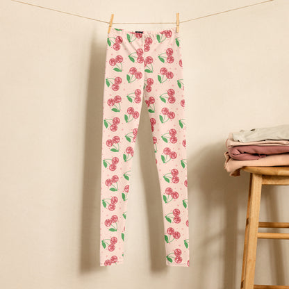 Brighten up her wardrobe with these made to order Disco Cherries Youth Girls Leggings, featuring a playful cherry pattern with vintage disco flair. Crafted from smooth microfiber yarn with four way stretch, these leggings are perfect for active girls who love fun fashion. Durable, soft, and vibrant, they pair perfectly with hoodies or tees for school days or dance practice. A cute cherry print outfit that brings color and comfort to every move.