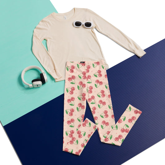 Playful and fun, these Disco Cherries Youth Girls Leggings feature a vibrant retro cherry print inspired by 70s fashion. Made to order with buttery soft microfiber yarn and four way stretch, these full length leggings are perfect for school, dance class, or lounging. Designed for active tweens and kids, they offer UPF 40 sun protection and lasting color. A cute and comfy choice for girls who love bright prints, soft girl style, and retro inspired outfits.
