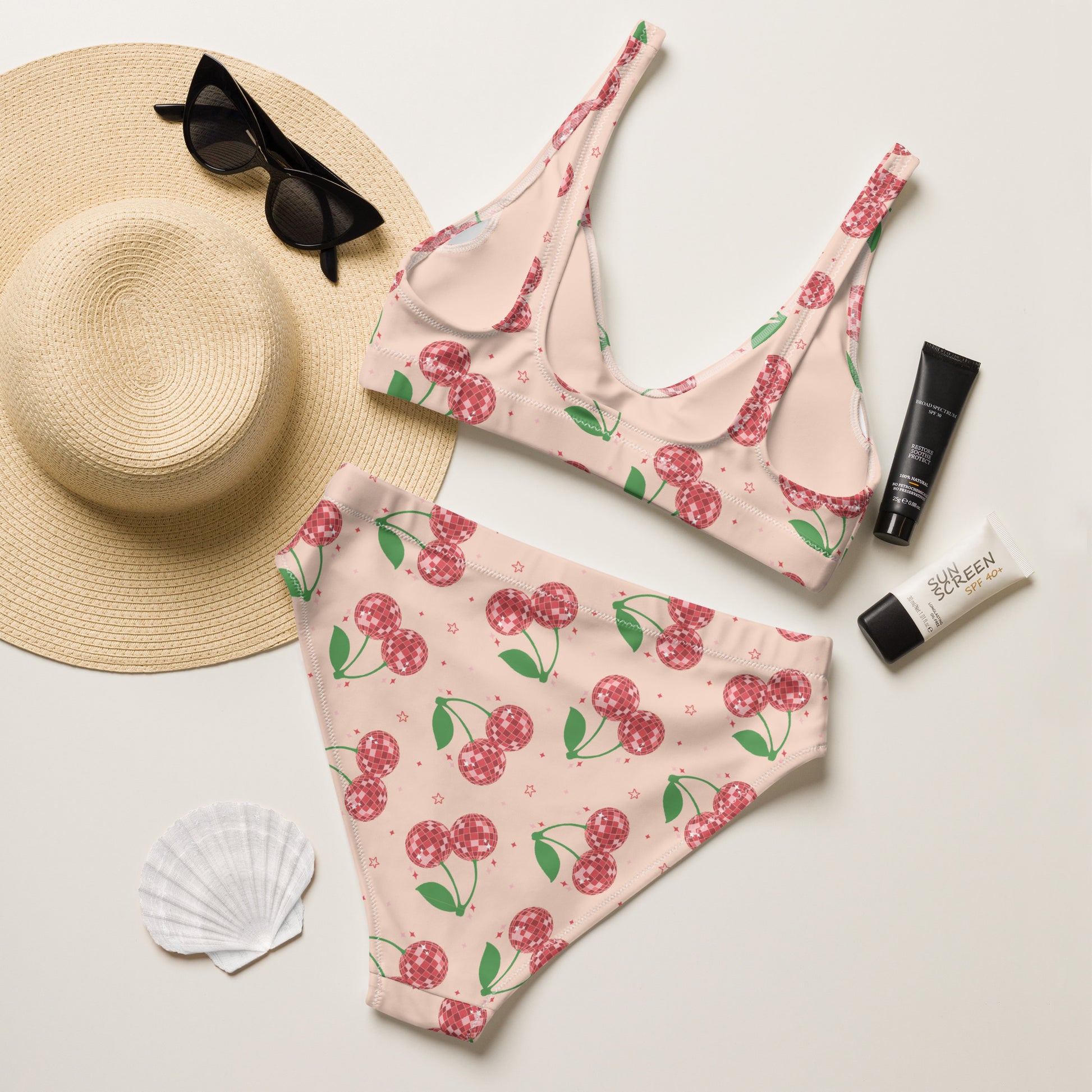 This pink women's bikini set features an all over disco ball cherry pattern that blends vintage style with modern summer trends. The high waisted bottoms provide comfortable coverage while the scoop neck top includes removable padding for a customizable fit. Crafted from recycled materials and available in sizes Small through 3XL, this swimsuit is part of a matching family swimwear collection perfect for beach trips, cruises, family photos, and summer vacations.