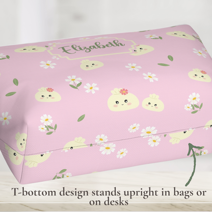 Pastel dumpling makeup bag with a whimsical pattern of smiling dumplings, delicate flowers, and green leaves. Personalize this cute accessory pouch with a name, nickname, or short phrase and choose your preferred font and personalization color. A versatile organizer for makeup, skincare, toiletries, hair accessories, chargers, school supplies, and travel essentials.