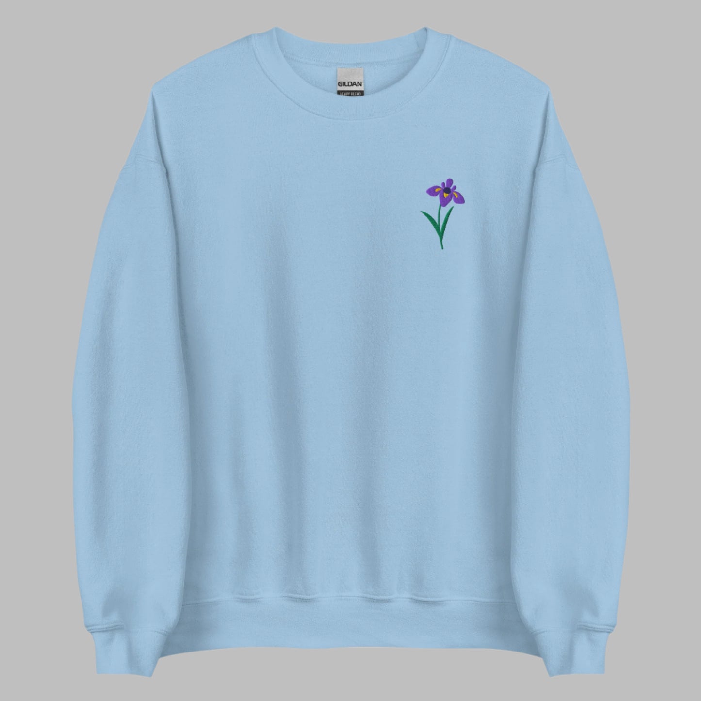 Image: A beautifully embroidered iris flower crewneck sweatshirt in a soft, relaxed fit. This custom floral design adds an elegant touch to any wardrobe, making it a meaningful Mother's Day gift or a thoughtful present for nature lovers. The intricate embroidery captures the essence of the bearded iris, creating a timeless piece that celebrates botanical beauty and personal style, by jaecrece.