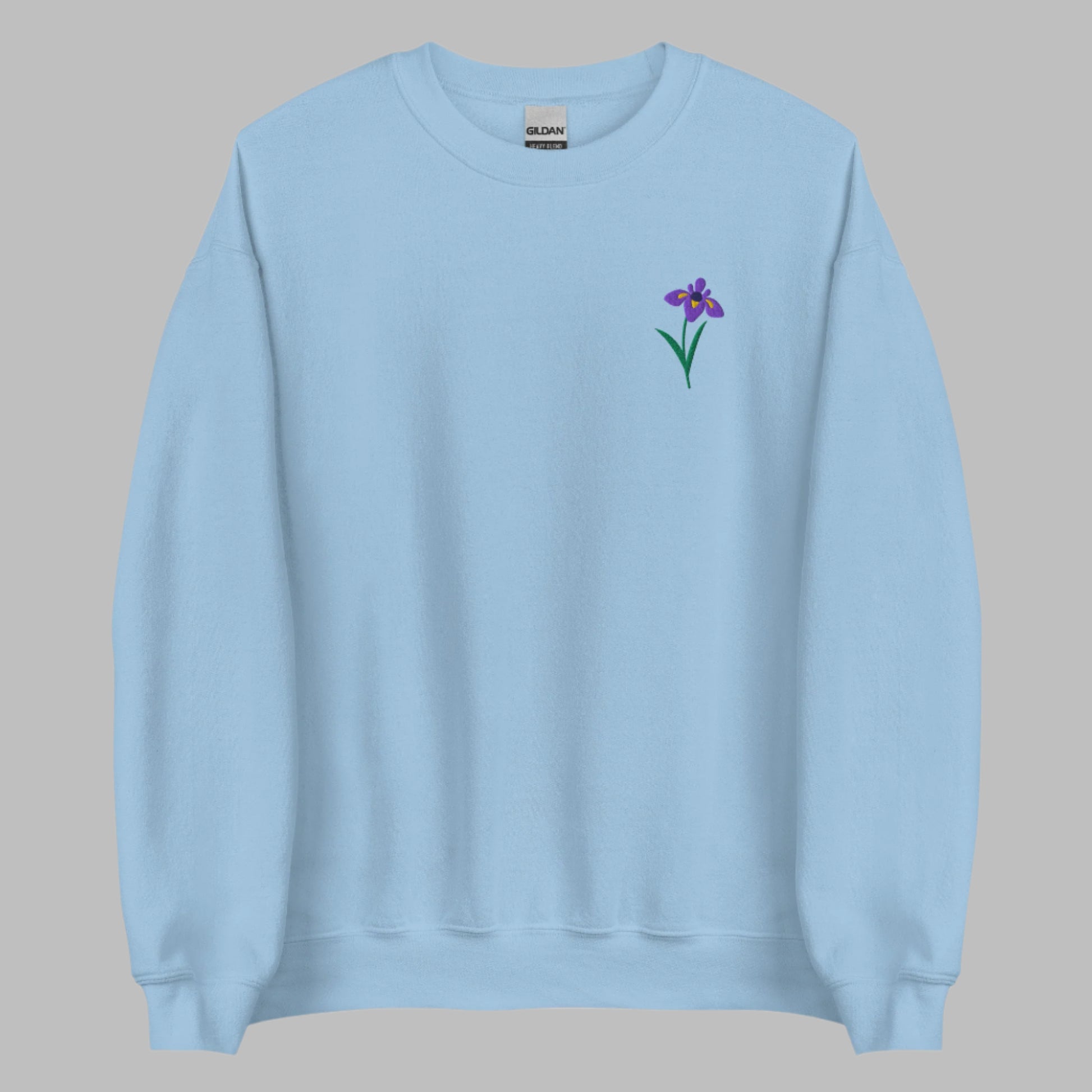 Image: A beautifully embroidered iris flower crewneck sweatshirt in a soft, relaxed fit. This custom floral design adds an elegant touch to any wardrobe, making it a meaningful Mother's Day gift or a thoughtful present for nature lovers. The intricate embroidery captures the essence of the bearded iris, creating a timeless piece that celebrates botanical beauty and personal style, by jaecrece.