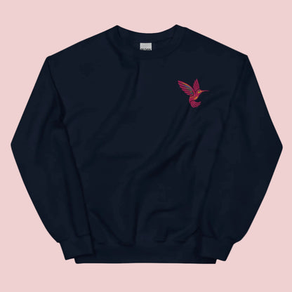 Embroidered hummingbird sweatshirt on Gildan 18000 crewneck featuring detailed bird stitching on soft cotton blend fabric. Cozy unisex pullover designed for everyday comfort and casual styling. Nature inspired sweatshirt perfect for bird lovers, garden aesthetic outfits, and cottagecore style. Ideal for women, moms, and gift giving. Available in sizes S to 5XL for relaxed fit layering and year round wear.