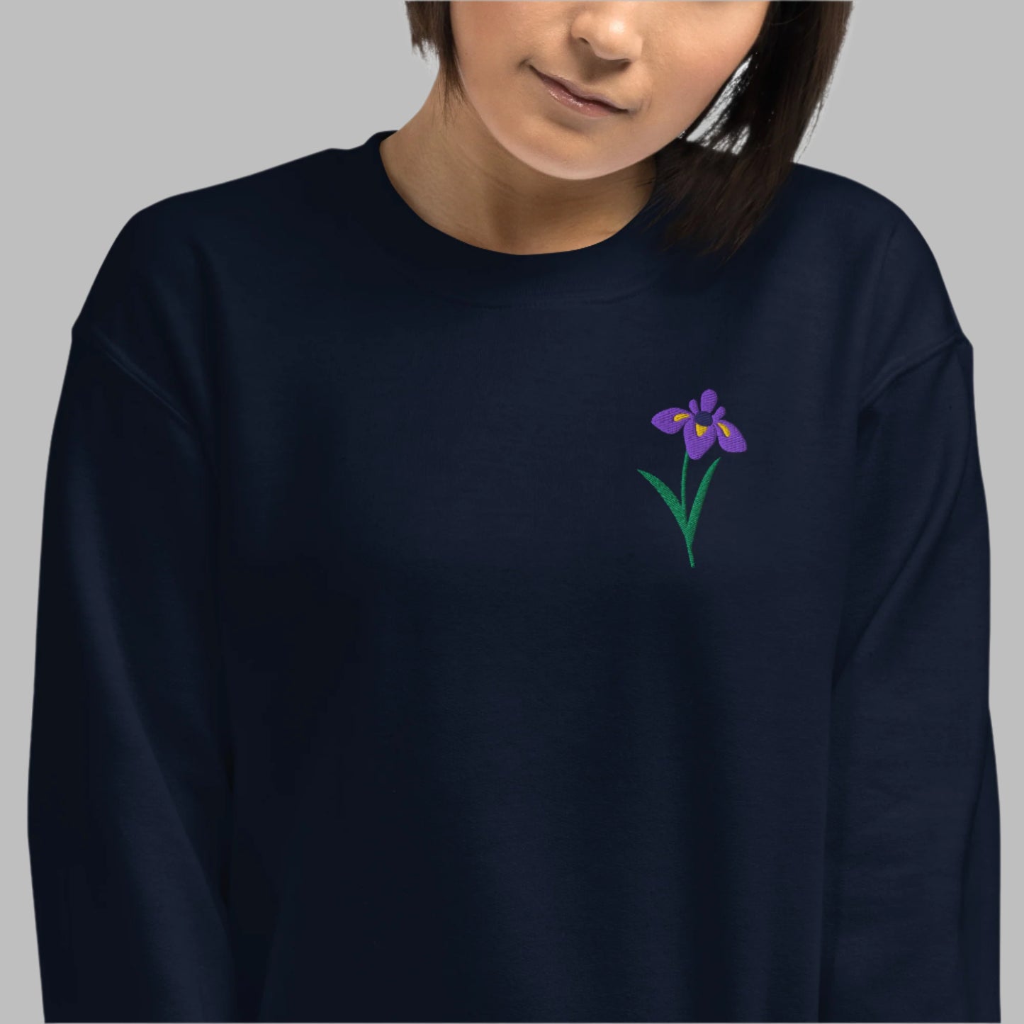 Image: A beautifully embroidered iris flower crewneck sweatshirt in a soft, relaxed fit. This custom floral design adds an elegant touch to any wardrobe, making it a meaningful Mother's Day gift or a thoughtful present for nature lovers. The intricate embroidery captures the essence of the bearded iris, creating a timeless piece that celebrates botanical beauty and personal style, by jaecrece.