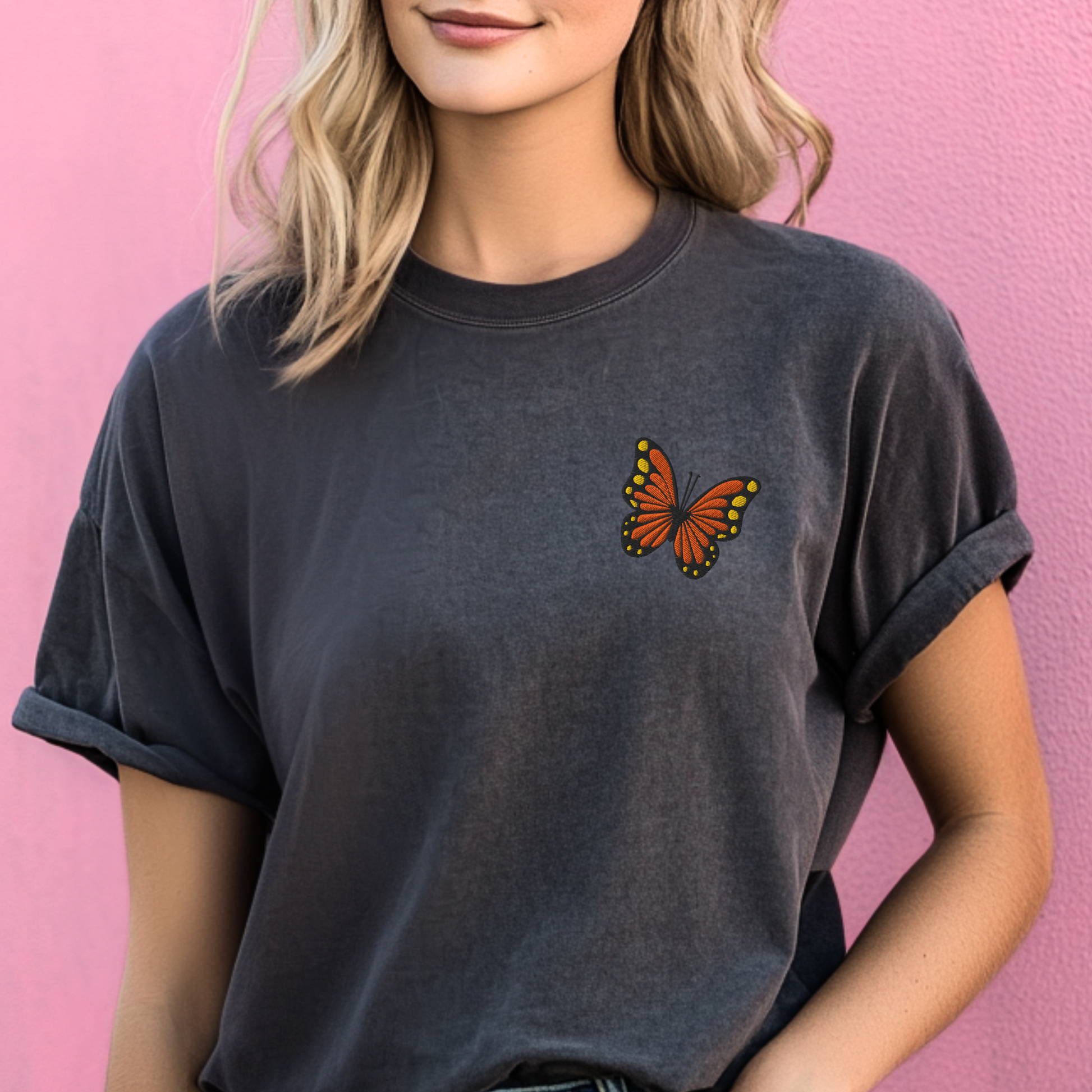 Image: Comfort Colors Pepper t-shirt with an embroidered monarch butterfly, perfect for embracing granola girl or clean girl aesthetic. With subtle spring energy and delicate embroidery, this breathable cotton tee fits right into minimal Earth Day outfits and is a lovely eco-friendly clothing gift for women who love bees, blooms, and butterflies, by jaecrece.