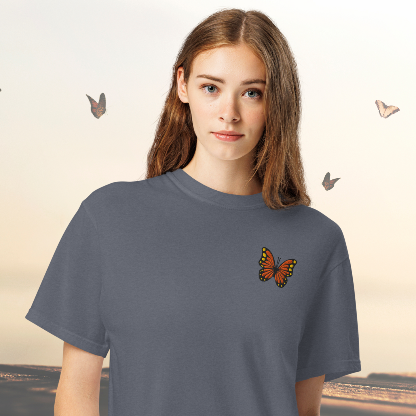 Image: Perfect for lovers of quiet elegance, this Monarch Butterfly Embroidered Shirt features intricate embroidery of a butterfly in flight, representing freedom and renewal. It is crafted on a cozy cotton tee in soothing tones, making it a lovely choice for everyday wear. Whether you are buying for a gardener, a teacher, or a friend who enjoys meaningful designs, this nature themed top celebrates the beauty of the outdoors with a touch of artistic flair, by jaecrece.