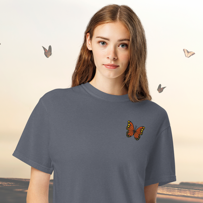 Image: Perfect for lovers of quiet elegance, this Monarch Butterfly Embroidered Shirt features intricate embroidery of a butterfly in flight, representing freedom and renewal. It is crafted on a cozy cotton tee in soothing tones, making it a lovely choice for everyday wear. Whether you are buying for a gardener, a teacher, or a friend who enjoys meaningful designs, this nature themed top celebrates the beauty of the outdoors with a touch of artistic flair, by jaecrece.