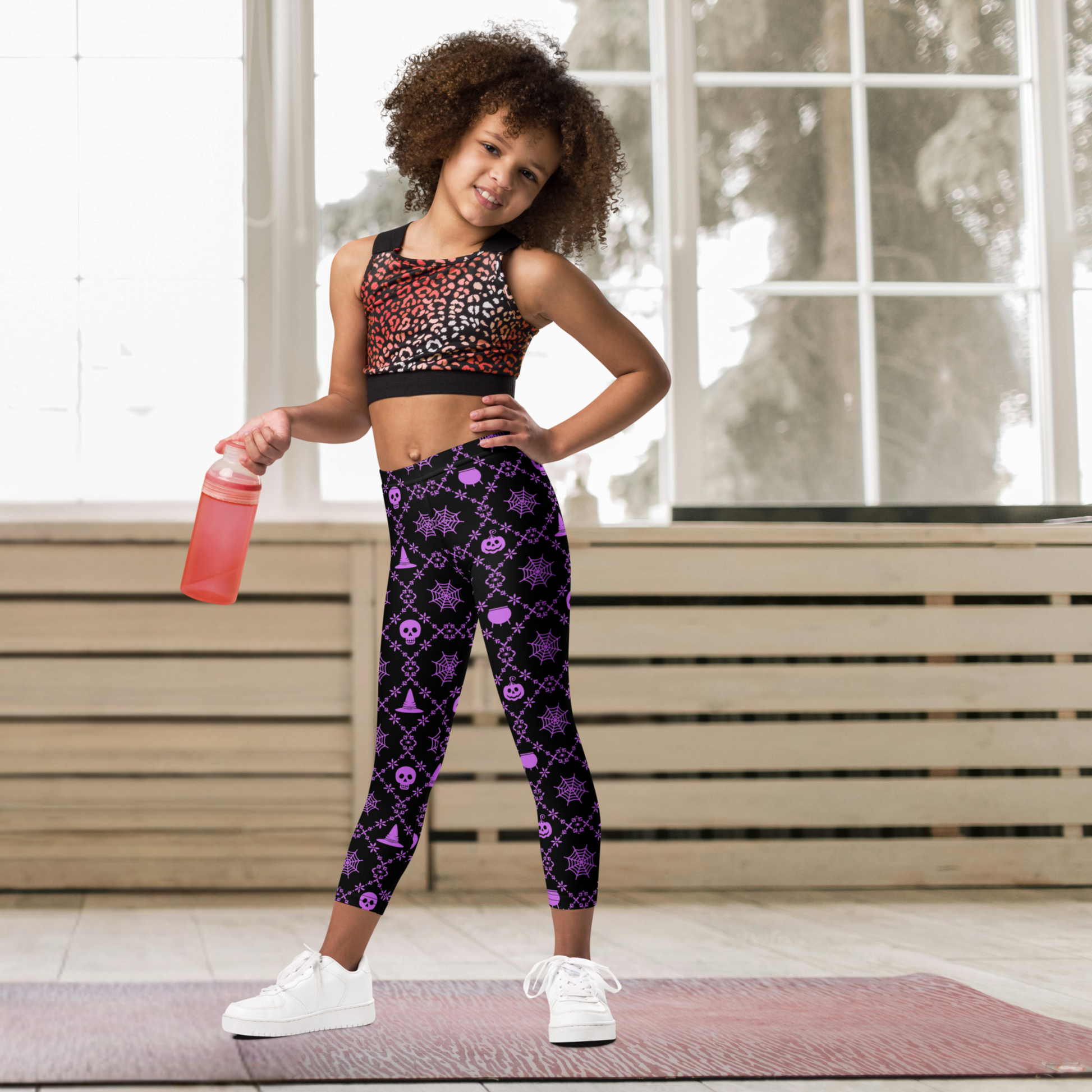 Kids Halloween leggings for toddlers, girls, tweens and teens featuring a purple geometric Halloween print on black, full length coverage and a high rise waist, perfect for spooky season outfits, Halloween parties, school events, pumpkin patches and trick or treating