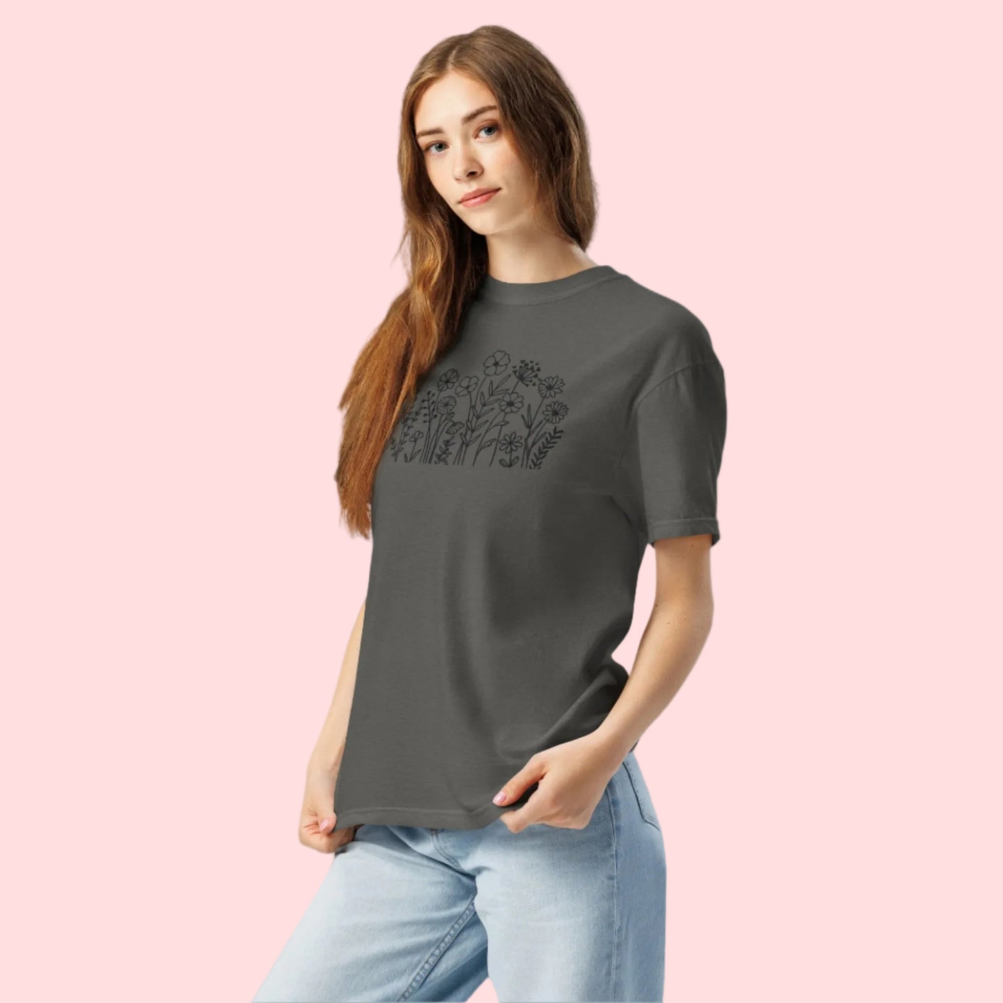 Image: A stylish dark grey crewneck shirt featuring black wildflower embroidery, blending a boho-chic aesthetic with classic casualwear. The floral pattern is stitched with precision, creating a subtle yet intricate nature-inspired motif. Whether paired with jeans or leggings, this embroidered sweater adds effortless charm to any wardrobe, making it an excellent gift for flower lovers and nature enthusiasts alike, by jaecrece.