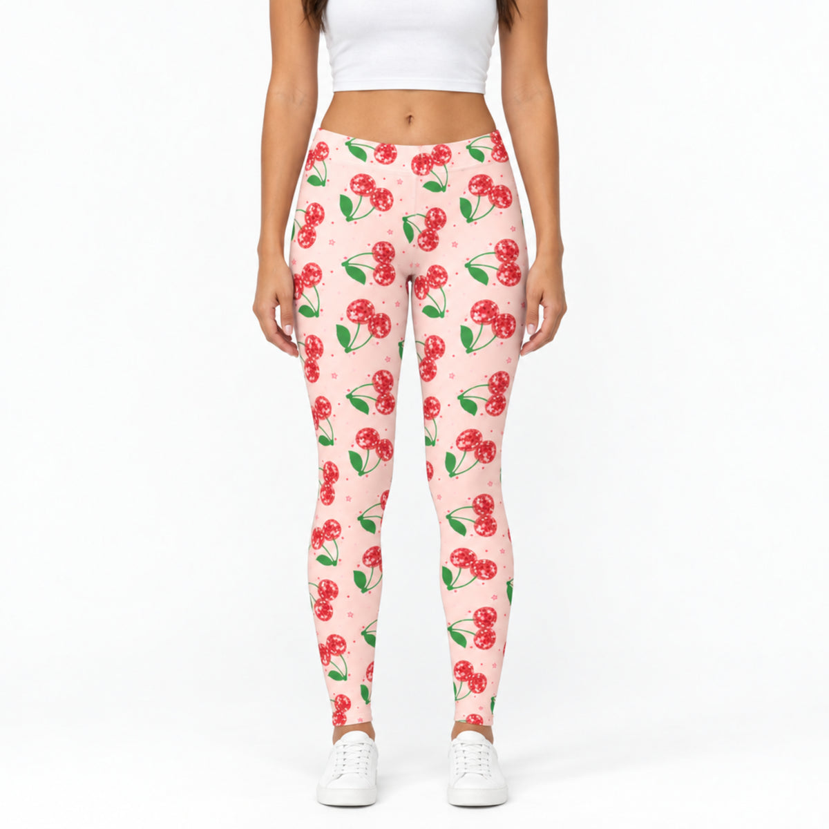 Front view of pink cherry print womens leggings showing the bright pink fabric, sparkling red cherry design, comfortable mid rise waistband and full length fit. The colorful retro print creates a playful Cherry Girl look while the simple front view clearly shows the actual leggings, proportions and design for shoppers.