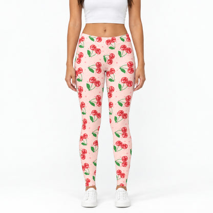Front view of pink cherry print womens leggings showing the bright pink fabric, sparkling red cherry design, comfortable mid rise waistband and full length fit. The colorful retro print creates a playful Cherry Girl look while the simple front view clearly shows the actual leggings, proportions and design for shoppers.