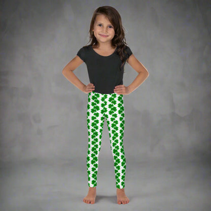 Image: St Patricks Day Leggings for toddlers and girls. Full-length girls’ leggings for St. Patrick’s Day feature a white base with rows of green shamrocks, perfect for toddlers and kids. These high-rise leggings in sizes 2T–7 are made from soft, stretchy fabric for comfort all day. Match them with youth and women’s sizes for a complete family outfit. Great for parades, parties, and March adventures. Also available in tween girl and womens sizes for family matching outfits, by jaecrece