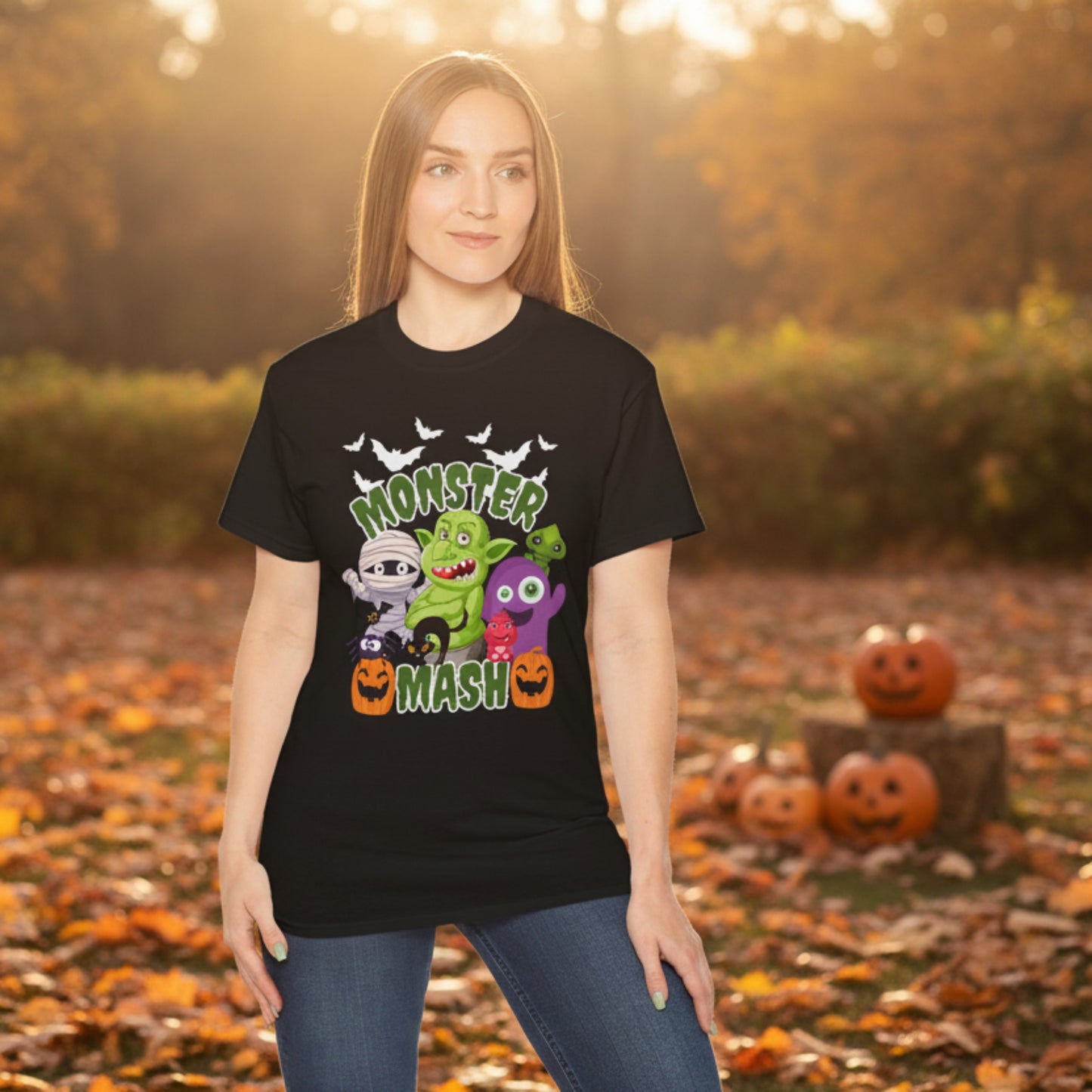 Fun Monster Mash Halloween t shirt with cartoon mummy, trolls, pumpkins, bats and black cat surrounding green slime text. Printed on a classic black or dark heather Gildan 2000 adult tee with relaxed unisex fit in sizes S through 5XL. Perfect for spooky season outfits, pumpkin patch days, Halloween events, family photos, handing out candy, fall graphic shirt, funny October tee, cute monster top.