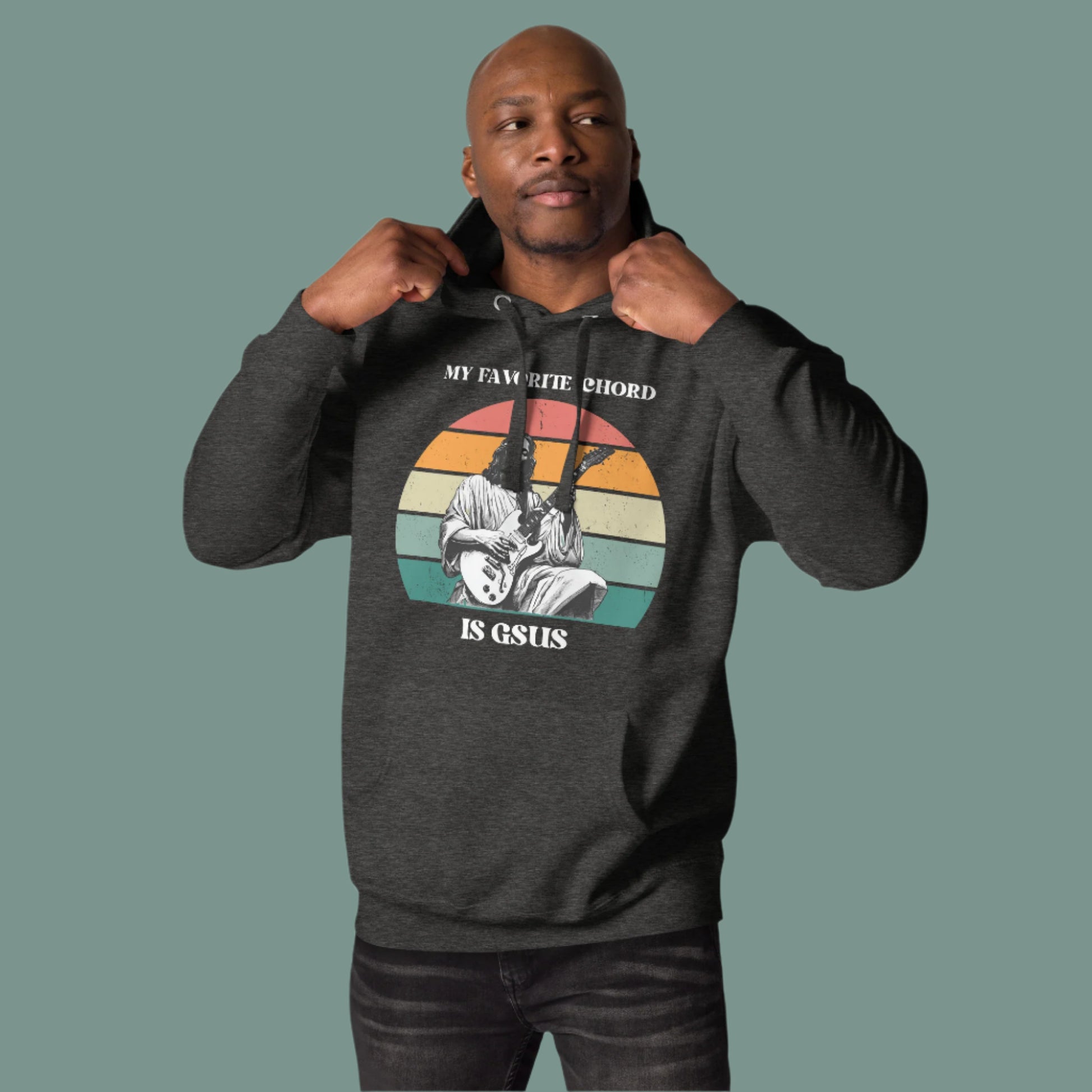 Front facing image of the “My Favorite Chord Is GSUS” unisex hoodie highlighting its soft fleece material and three panel hood design. Featuring a playful Christian music pun, this comfortable pullover is perfect for worship teams, band rehearsals, and casual wear. Available in sizes small to 3XL, it fits a wide range of body types.

