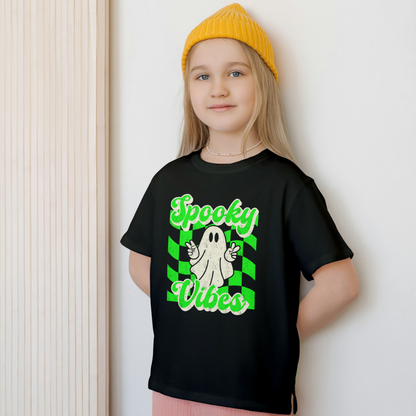 Black Spooky Vibes Child Shirt with a bright green checkerboard pattern and a cute ghost showing the peace sign. The text reads Spooky Vibes. This Halloween tee is perfect for girls and boys! By jaecrece