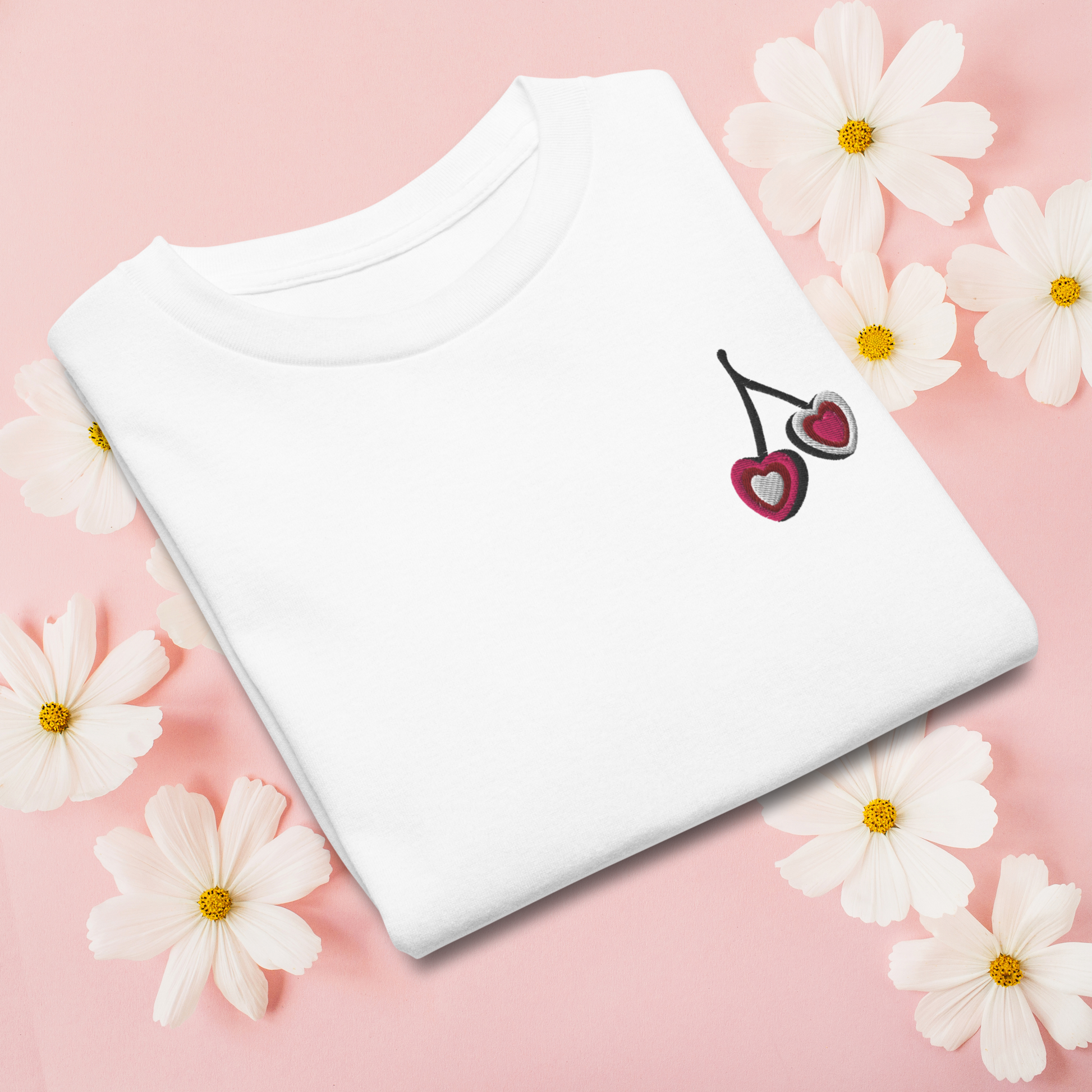 Girls embroidered cherry shirt made from soft, breathable cotton with a small heart shaped cherry detail. Available in white, natural, and azalea, this top is perfect for everyday wear, whether she is heading to school, playing outside, or going out with family. The clean, simple design gives it a timeless feel, while the embroidery adds just enough personality to make it special.