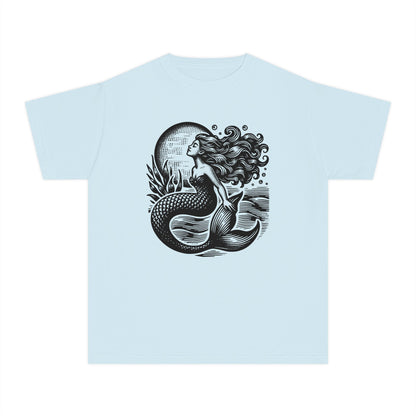 Girls Comfort Colors mermaid t shirt featuring a linocut inspired coastal illustration of a mermaid rising through textured ocean waves beneath a bright full moon. Soft garment dyed youth graphic tee with a relaxed vintage feel perfect for beach vacations summer outfits school days and matching mommy and me looks. Ideal for ocean loving girls who love nautical fashion mermaidcore style seaside adventures whimsical artwork and trendy coastal aesthetic clothing with comfortable everyday wear appeal.