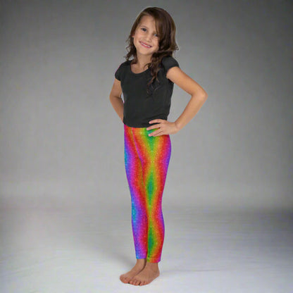 Toddler and girls’ faux glitter leggings with a holographic swirl print in rainbow colors, available in sizes 2T to 7. Perfect for toddlers and little girls at Pride, Mardi Gras, festivals, or dance class. These stretchy, comfortable leggings are part of a family matching collection that celebrates color, fun, and movement. A perfect mix of style and comfort.