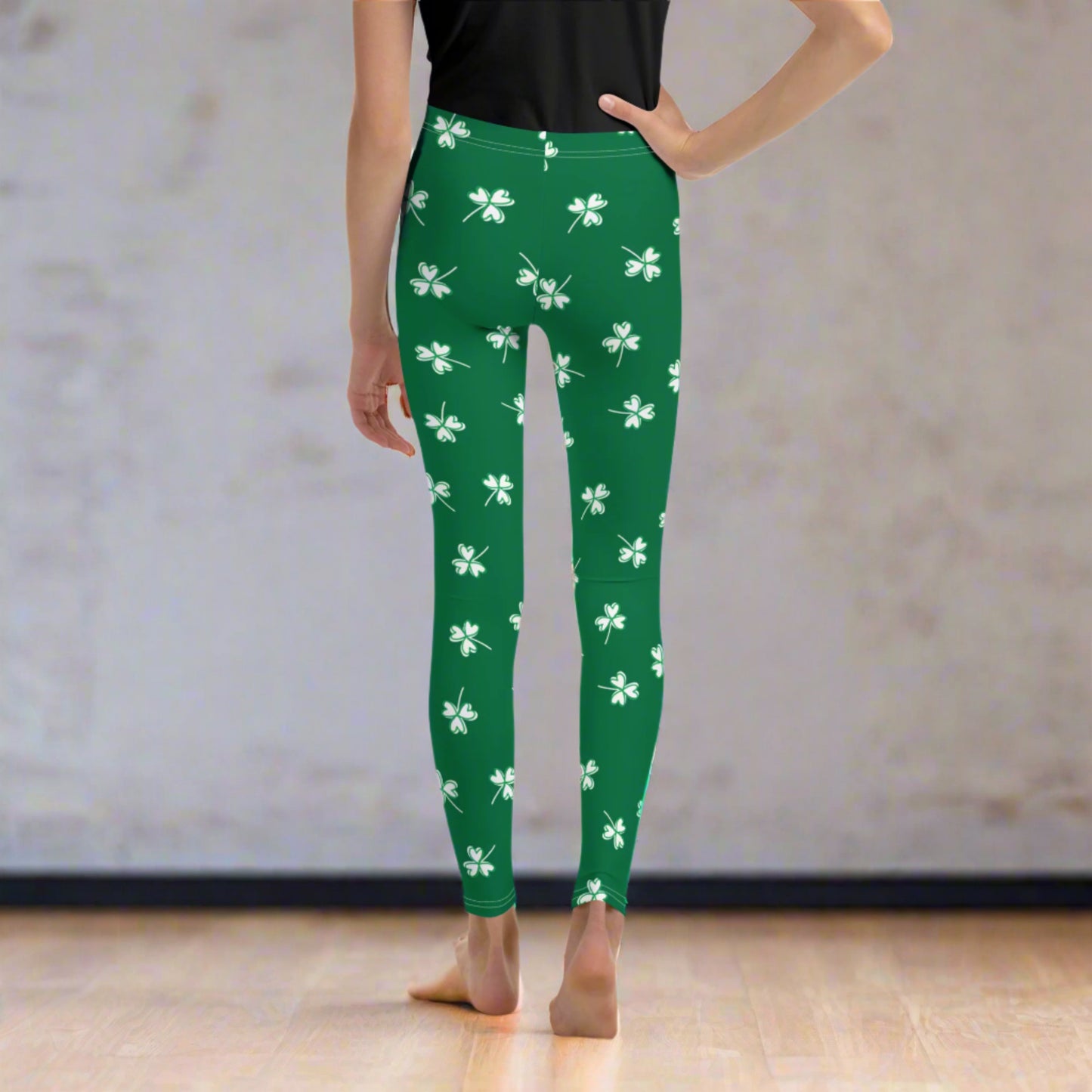 Image: Family Matching St Patricks Day Shamrock Leggings. Festive yoga pants with green background and white four leaf clovers. Available in sizes for toddler girls, teens, tweens, and women. Perfect for a St Pattys Day parade or fun run, by jaecrece