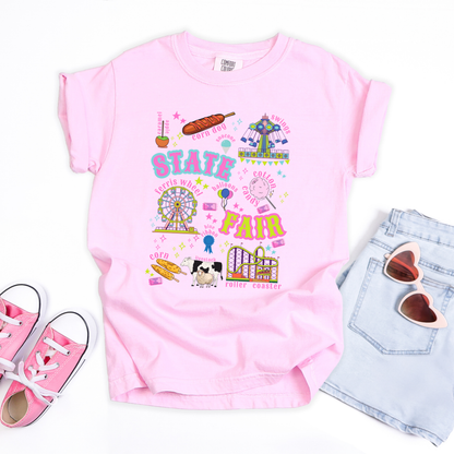 Kids retro carnival T shirt featuring a colorful fair themed graphic with bold STATE FAIR lettering surrounded by a Ferris wheel, roller coaster, carnival swing ride, cotton candy, funnel cake, corn dogs, balloons, livestock, blue ribbon and colorful fair tickets. Perfect for a nostalgic summer fair outfit.