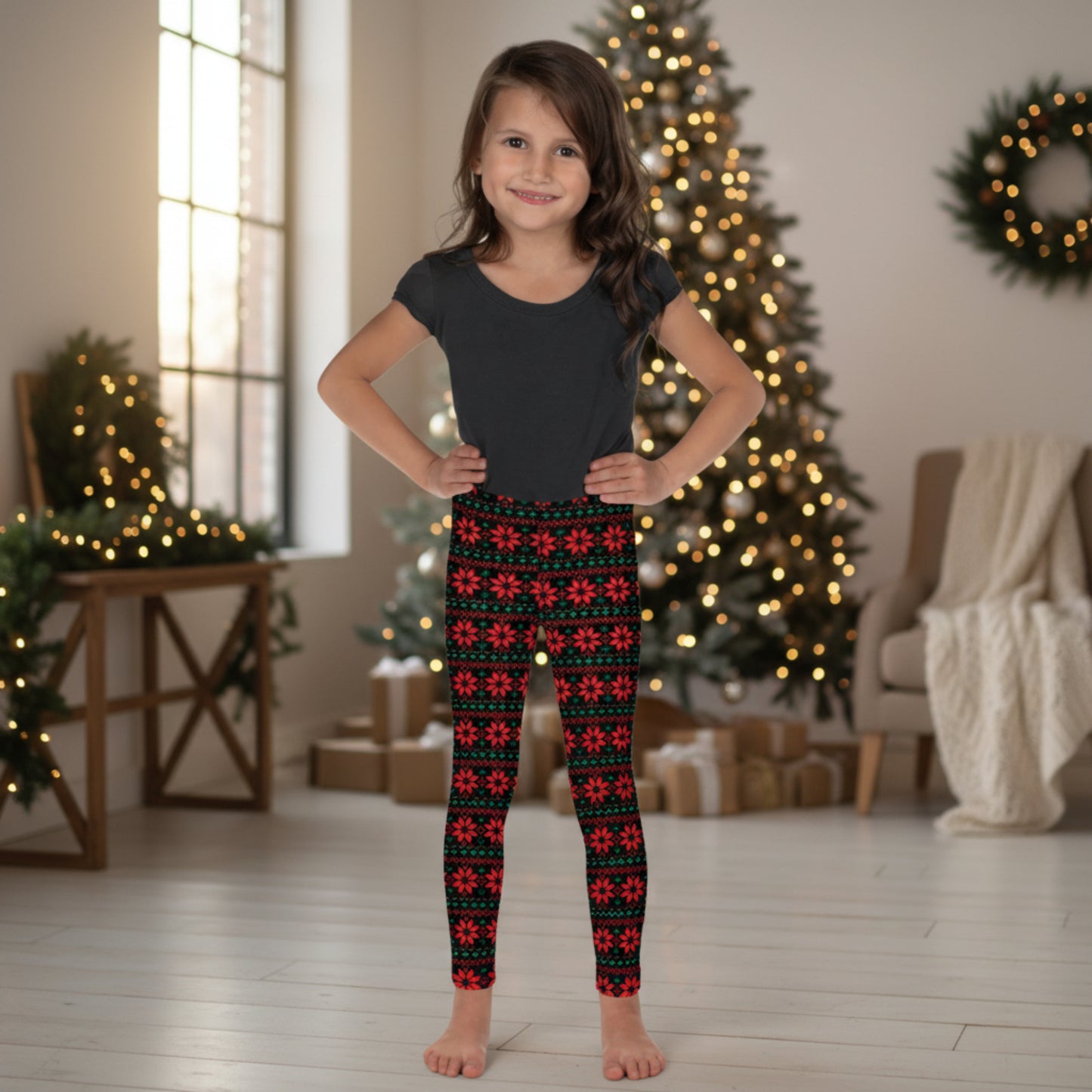 Girls holiday leggings with red poinsettias, green leaves and a black background create a festive Fair Isle inspired Christmas pattern. The full length design reaches the ankle and features a high rise waist. Available in sizes 2T–20 for parties, photos and seasonal celebrations.