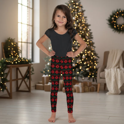Girls holiday leggings with red poinsettias, green leaves and a black background create a festive Fair Isle inspired Christmas pattern. The full length design reaches the ankle and features a high rise waist. Available in sizes 2T–20 for parties, photos and seasonal celebrations.