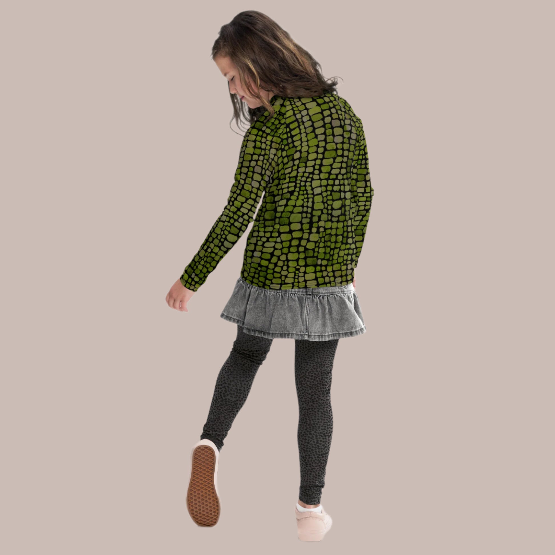 Youth long sleeve rash guard with green reptile pattern in sizes 8–20, perfect for snake, dinosaur, and lizard costumes. Ideal for swimming, beach play, and sunny days, it offers UPF protection and bold, all-over print style. Designed for tweens who enjoy dressing up, exploring, and having fun outdoors. Great for jungle themes, summer camps, or costume parties. A unique swimwear piece for animal lovers.