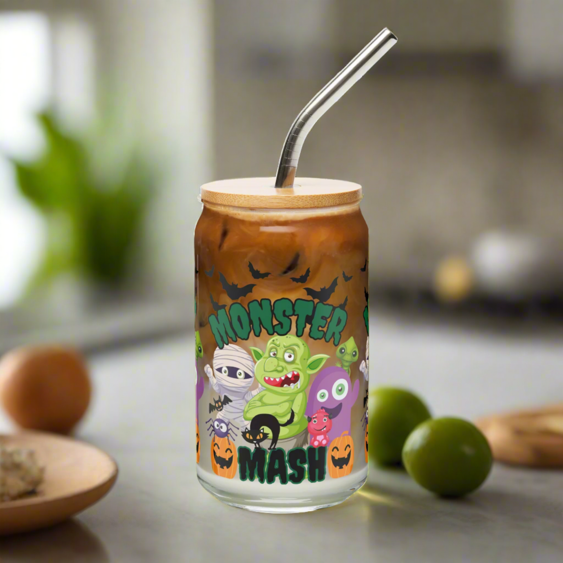 Halloween Monster Mash sipper glass, 16 oz size with bamboo lid and stainless steel straw included. Features fun monster characters, pumpkins, and bats for a festive look. Perfect iced coffee cup, cocktail glass, or sparkling water tumbler for spooky season entertaining. Eco-friendly reusable drinkware that makes a thoughtful fall gift for friends, coworkers, or teachers. Cute seasonal beverage glass for Halloween and autumn celebrations.