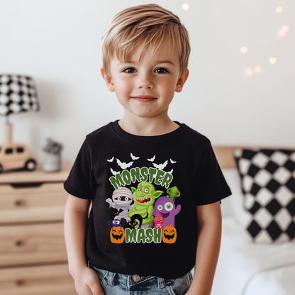 Monster Mash Halloween t shirt featuring a fun cartoon group of spooky characters including bats, zombie, troll, mummy, ghost, black cat, and pumpkins printed on a black Bella Canvas tee. The design includes bright green slime Monster Mash lettering for a playful Halloween look, perfect for kids, youth, and adults. Great for pumpkin patch trips, trick or treating, school parties, and matching family Halloween outfits.