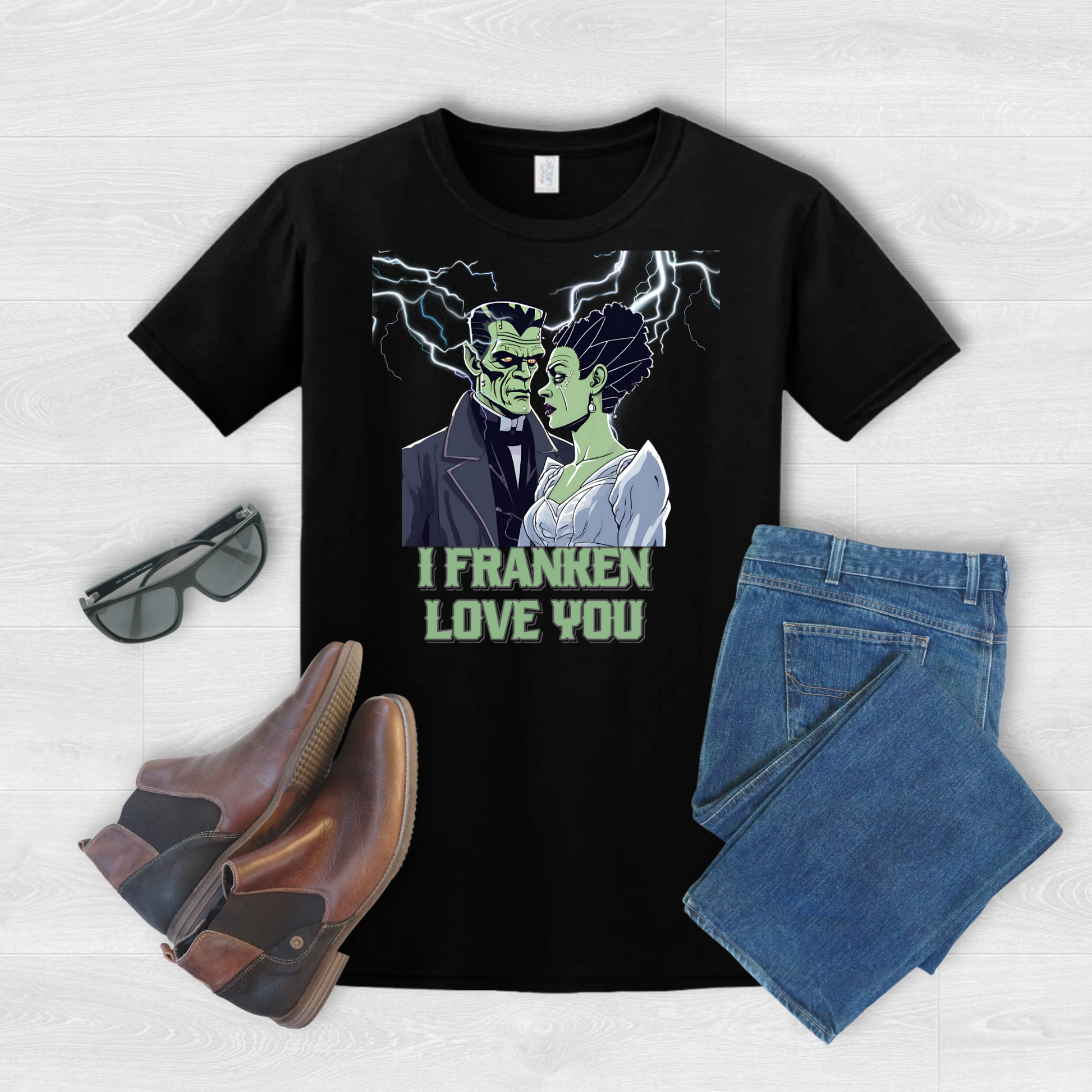 Unisex black Halloween shirt featuring romantic Frankenstein and bride, dramatic lightning scene, reading “I Franken Love You.” Gildan 64000 tee, sizes S-5XL, ideal for spooky couples, Halloween parties, novelty gifts, or festive casual outfits.