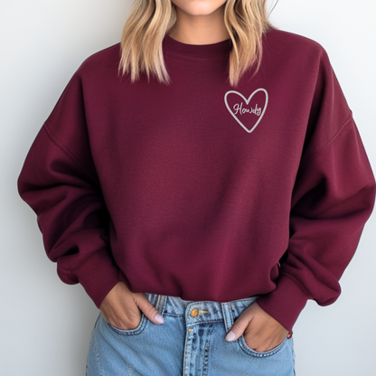 Embroidered Howdy sweatshirt made on Gildan 18000 heavy blend crewneck featuring soft cozy fabric and relaxed unisex fit. Western inspired pullover with bold stitched lettering designed for everyday comfort and casual style. Available in multiple colors including black, maroon, forest green, heliconia, and dark heather. Perfect country aesthetic sweatshirt for women, cowgirl outfits, country concerts, errands, travel, and cozy lounge wear.