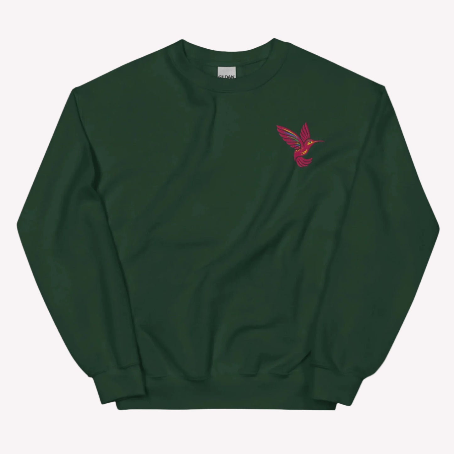 Soft hummingbird embroidered sweatshirt with detailed bird design on classic Gildan 18000 unisex crewneck. Comfortable cotton and polyester blend ideal for everyday wear and layering. Nature inspired aesthetic perfect for women who love birds, gardens, and cozy outfits. Great for casual styling, travel, and gifting. Available in sizes S to 5XL.