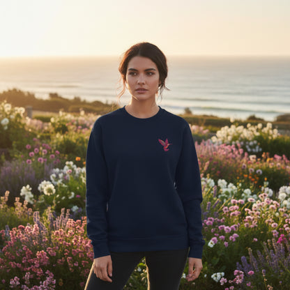 Nature inspired embroidered hummingbird sweatshirt styled as an easy everyday outfit. The colorful hummingbird adds a delicate pop of detail to the classic crewneck design without covering the front of the sweatshirt. This casual style works well for coffee runs, weekend outings, relaxing at home, or layering on cooler days and makes a thoughtful gift for someone who loves birds, gardens, and the outdoors.