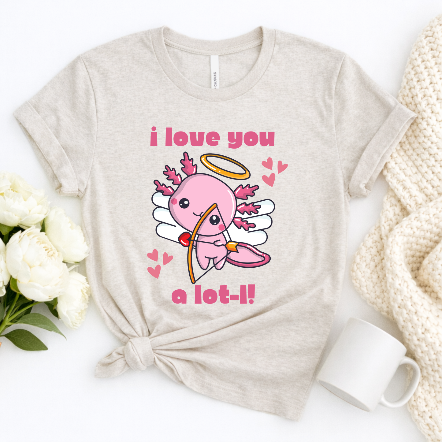 Heather Dust Bella Canvas 3001 tshirt featuring the I Love You A Lot L Axolotl Cupid artwork with a charming axolotl cupid and playful lettering. Soft unisex tee offered in adult sizes XS to 5XL with child sizes available for matching sets. The neutral heather dust shade gives the design a modern everyday look that pairs easily with jeans or leggings. Lightweight comfortable shirt for Valentine parties, errands, relaxed weekends, family photos, or thoughtful gifts for animal lovers.