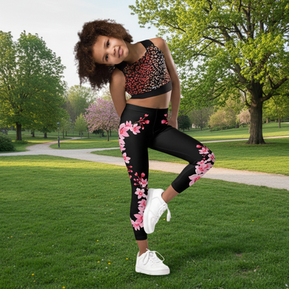 Image: Japanese Cherry Blossom Girls and Toddler Leggings, in sizes 2T, 3t, 4T, 5T, 6, 6X and 7. Black leggings with a swirl of Japanese cherry blossoms going down the outside of each leg.  Elastic, soft, and durable with vibrant colors. Part of a matching collection for younger children and women, each pair is precision-cut and hand-sewn for a perfect fit.