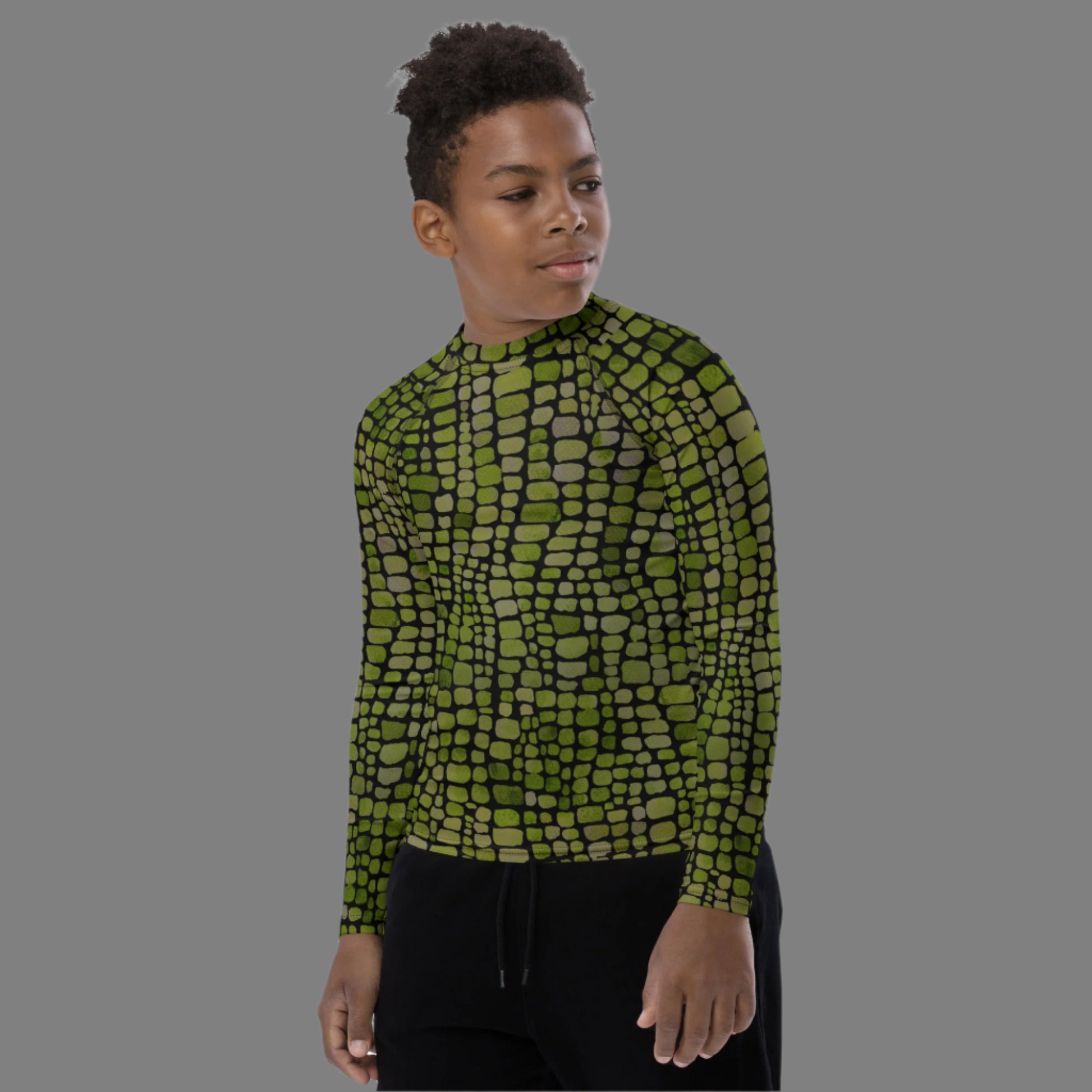 Kids green reptile rash guard in youth sizes 8–20, designed with an all-over scale pattern that’s perfect for wild animal costumes and active swimwear. Whether dressing up as a dinosaur, snake, or lizard, this UPF long sleeve shirt keeps them protected during water play. Great for beach adventures, poolside fun, and jungle-themed birthday parties. A bold choice for kids who love to make a splash.