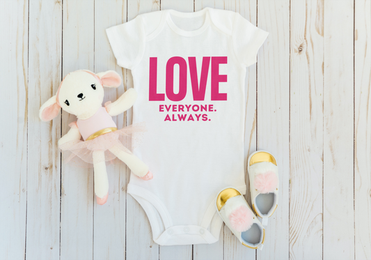 White baby onesie that says "LOVE Everyone. Always" in hot pink block letters.