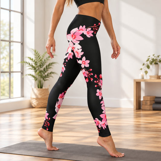 Women’s full length cherry blossom leggings featuring delicate pink sakura flowers and flowering branches on a black background. The mid rise leggings have a feminine Japanese inspired floral design and stretchy fabric, making them comfortable for everyday outfits, spring wear, travel, sightseeing, and cherry blossom season.