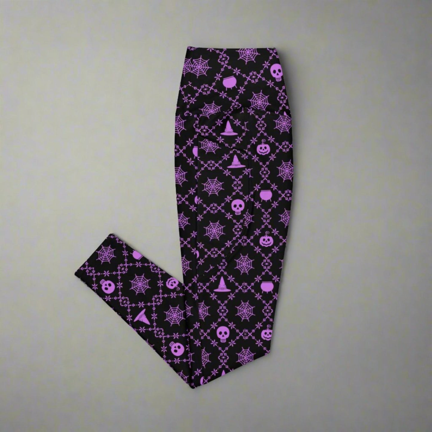 Wickedly Cute Ladies Halloween Leggings, featuring a black material with a purple geometric pattern that consists of spiders webs, pumpkns, witches hats and skulls, by jaecrece.com