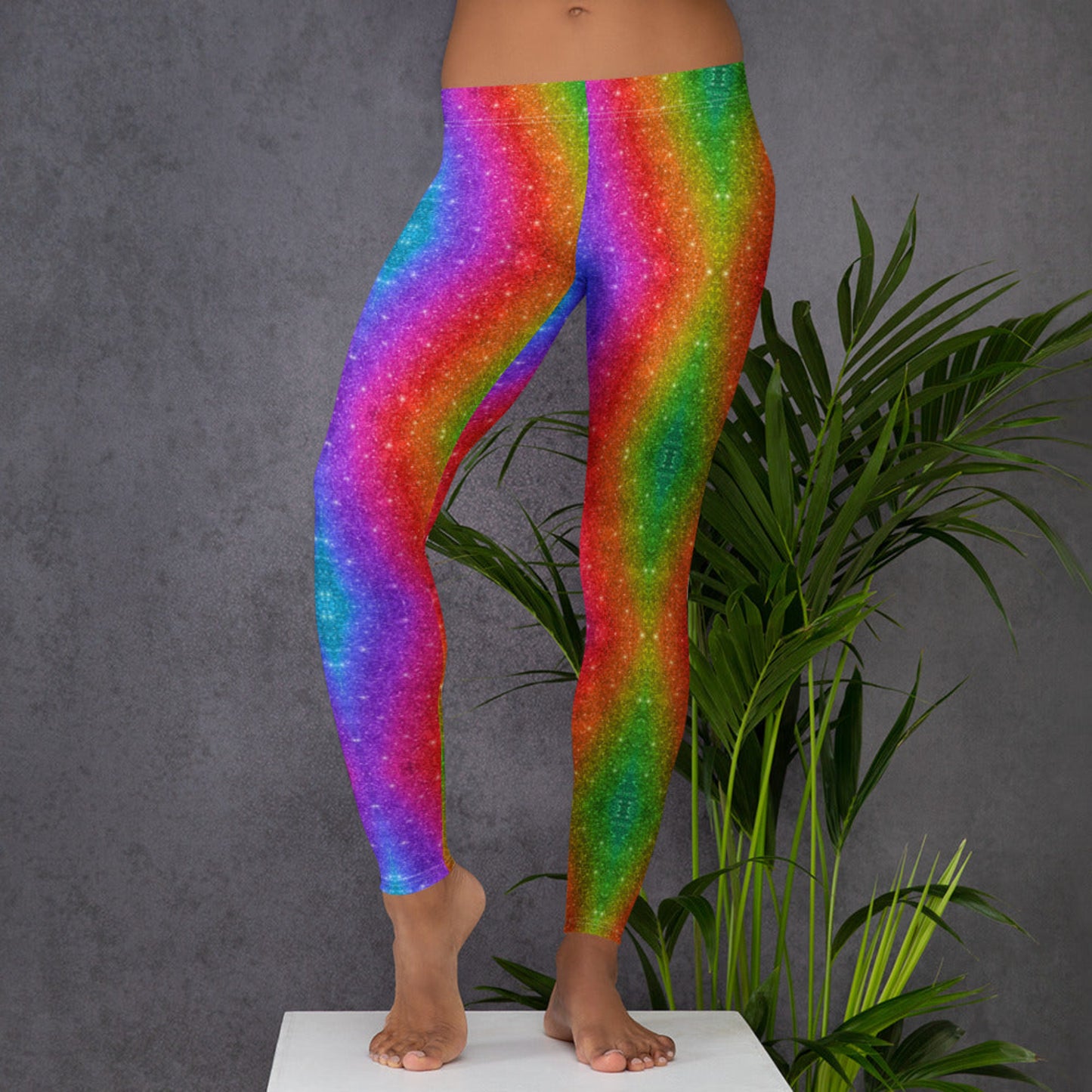 Bright rainbow holographic swirl print women’s leggings that sparkle like glitter—without the mess! These bold, stretchy leggings are a favorite for festival fashion, parade outfits, Pride walks, and color run 5Ks. With a soft microfiber feel, mid-rise waist, and breathable fabric, they’re perfect for vibrant everyday style and family-matching looks.