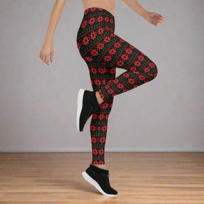 Women’s Christmas leggings featuring a black background with red and green poinsettia pattern in a geometric fair isle style. Mid rise waist and full length fit to the ankle create a flattering silhouette for holiday parties, cozy nights, and festive everyday wear. Perfect for matching family outfits, mommy and me looks, winter fashion, and shoppers searching for soft comfortable holiday leggings with standout Christmas style.