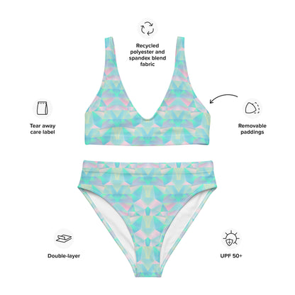 Image: A striking two piece bikini with a high waisted fit and a unique pastel prism print in shades of teal, blue, and pink. The geometric design adds a playful yet sophisticated touch, while the recycled fabric offers an environmentally friendly swimwear option. Whether relaxing on the beach or enjoying a summer getaway, this swimsuit is designed to turn heads while being kind to the planet, by jaecrece.