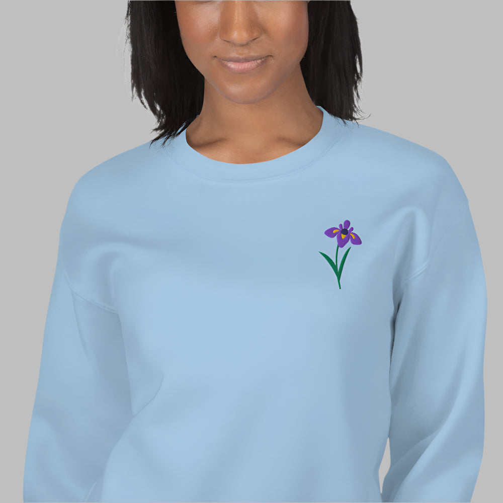 Image: A beautifully embroidered iris flower crewneck sweatshirt in a soft, relaxed fit. This custom floral design adds an elegant touch to any wardrobe, making it a meaningful Mother's Day gift or a thoughtful present for nature lovers. The intricate embroidery captures the essence of the bearded iris, creating a timeless piece that celebrates botanical beauty and personal style, by jaecrece.